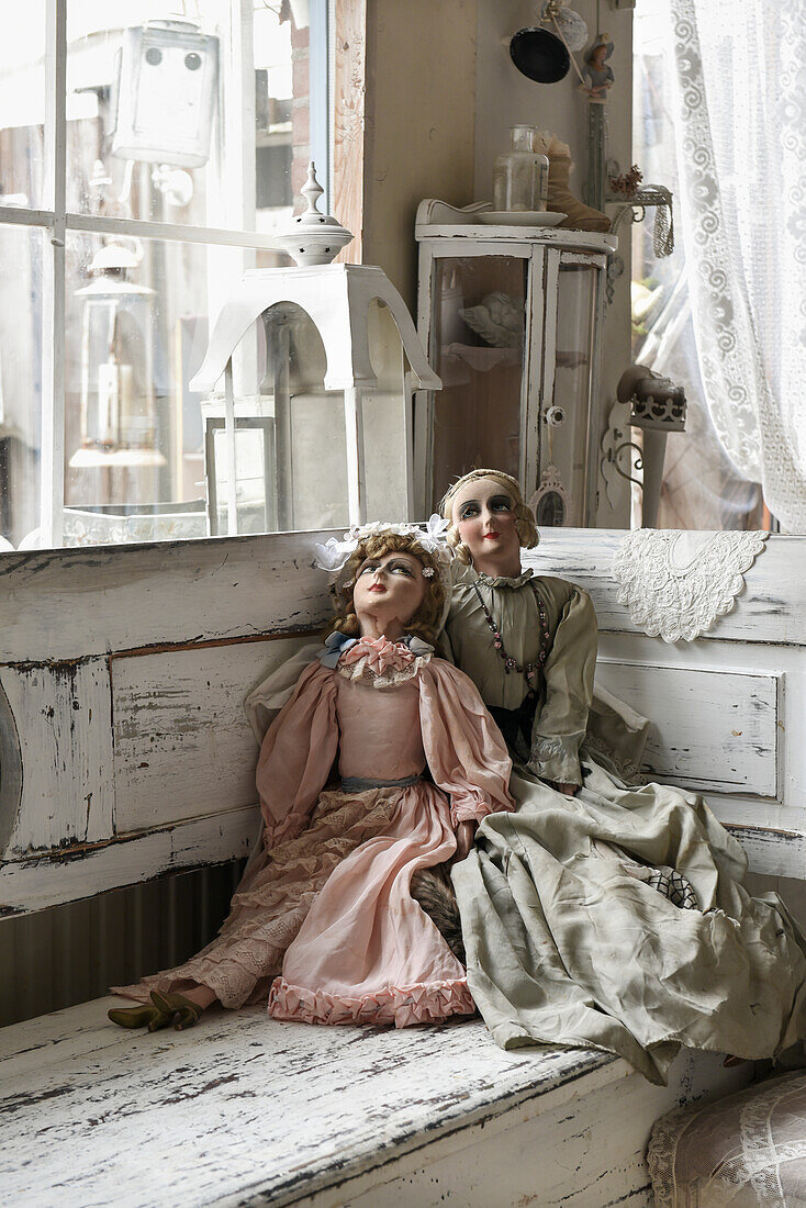 Old dolls on vintage wooden bench