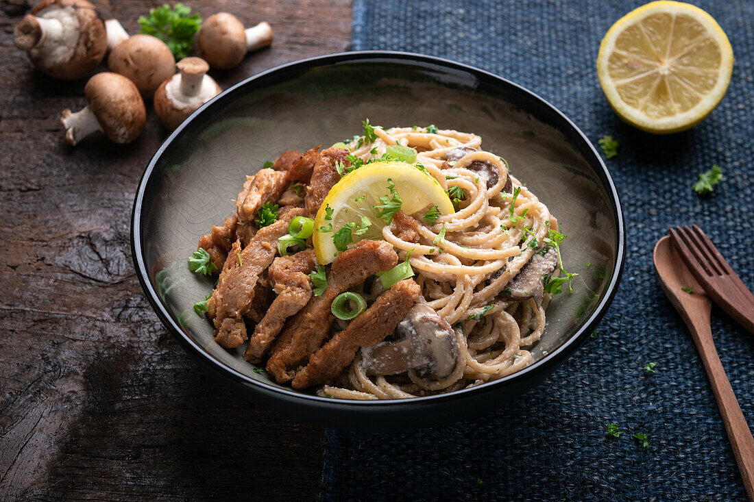 Wholemeal spaghetti in mushroom-cashew 'cream' with fried soy fillet