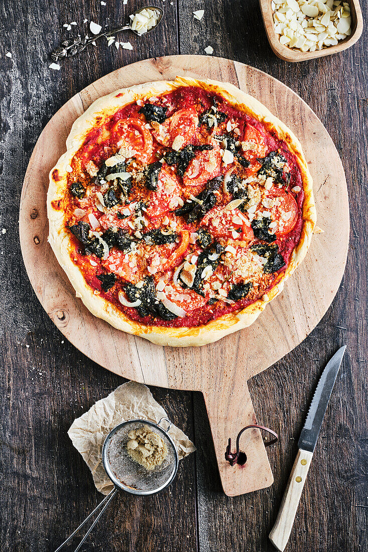 Vegan wild garlic pizza with parmesan substitute