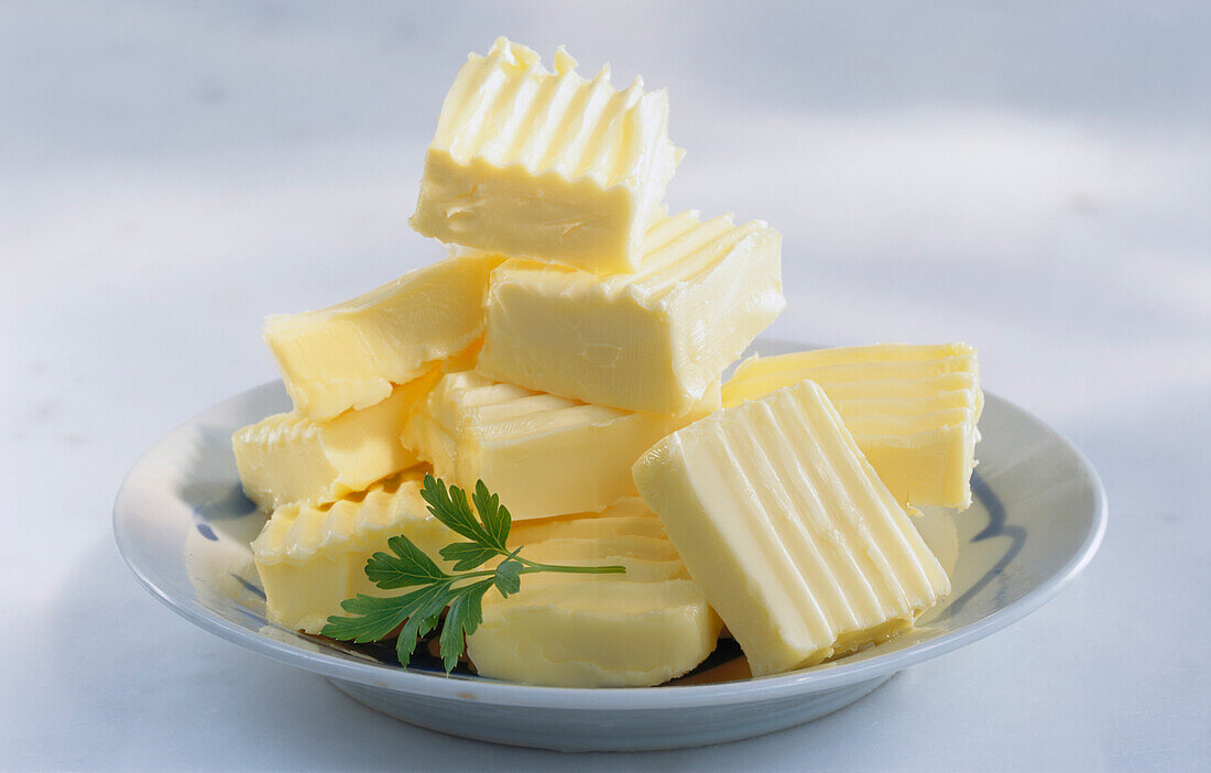 Pieces of butter stacked on a plate