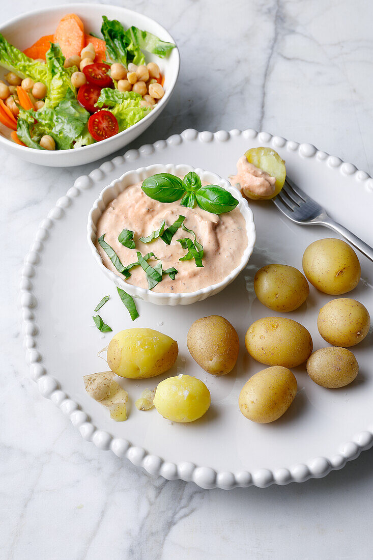Baked potatoes with pesto curd quark and salad