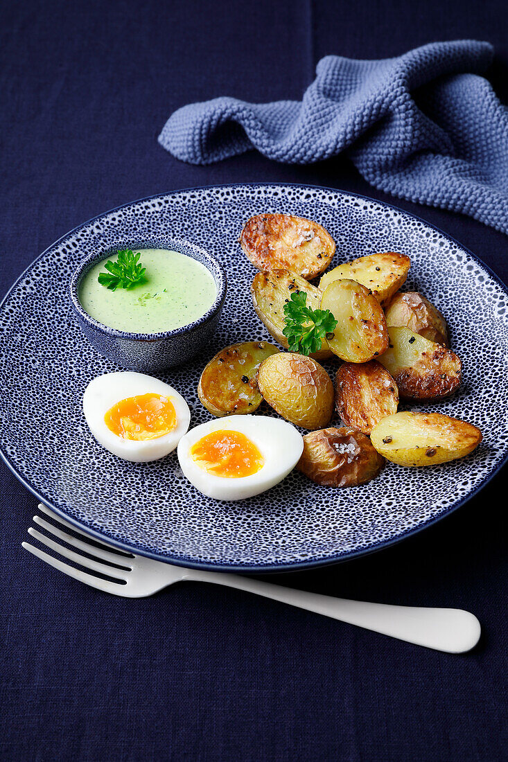 Baked potatoes with green sauce and waxy egg