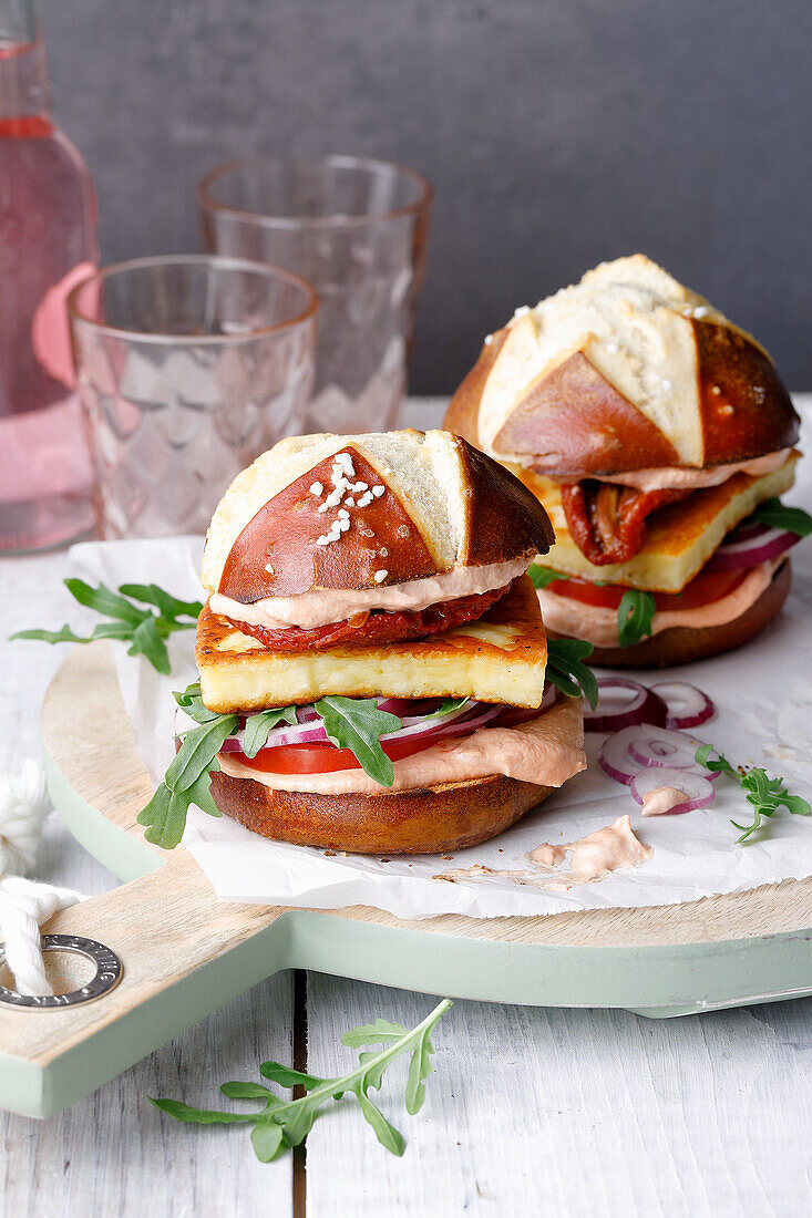 Tomato burgers in pretzel buns with grilled cheese