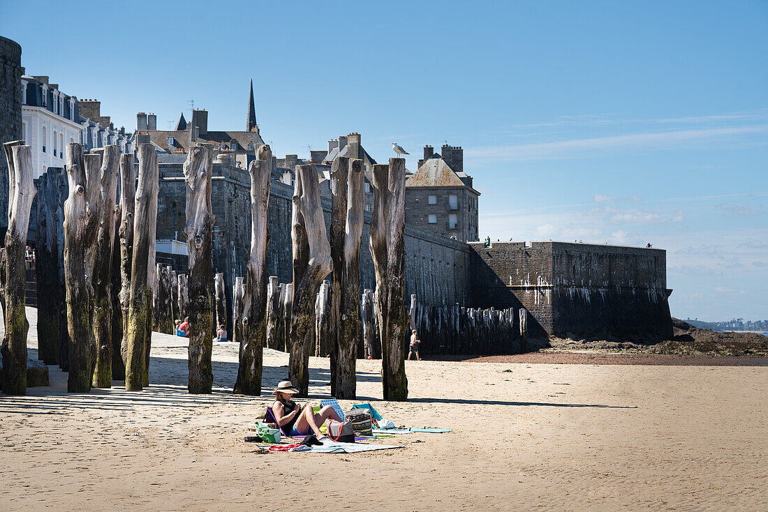 A beach with tree trunks as breakwaters, Saint-Malo, Brittany, France