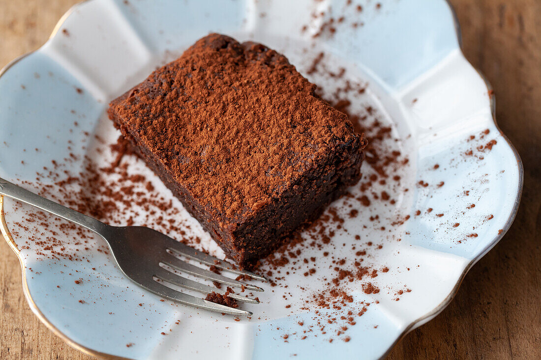 A brownie with cocoa powder