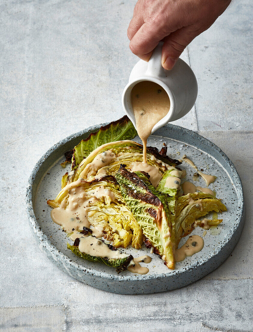 Roasted savoy cabbage with vegan 'cheesy' pepper sauce