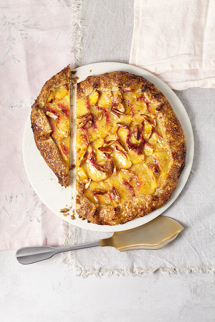 Peach and poppy seed crostata (poppy seeds are in the batter) with cardamom and spelled flake crumble