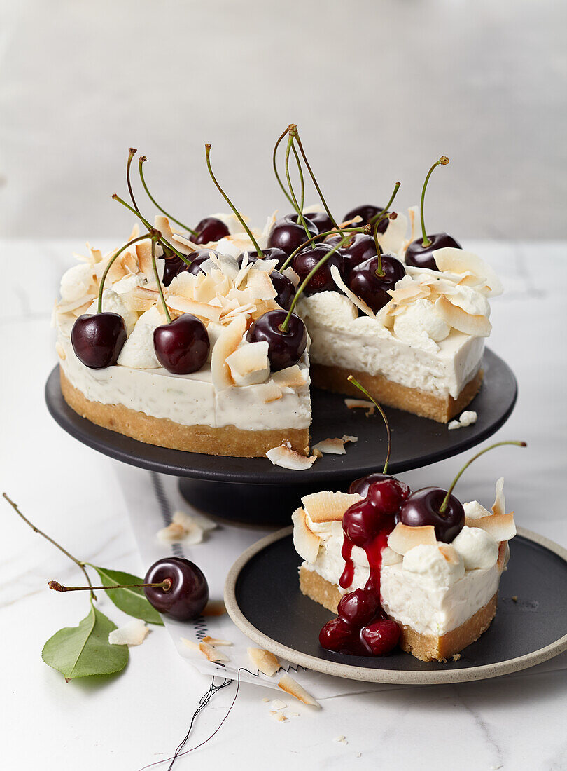 Coconut rice pudding cake with lemongrass, cherries, lime shortbread base and toasted coconut chips