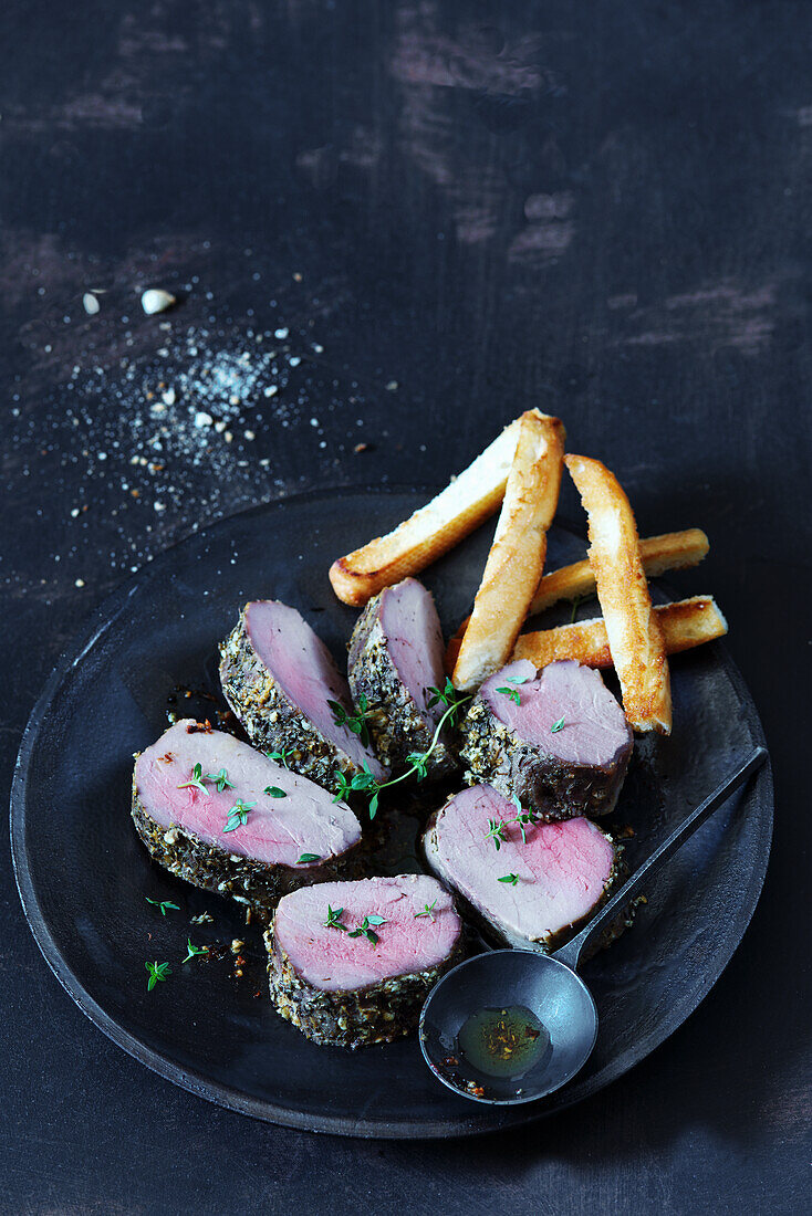 Pork tenderloin with herb crust and fries