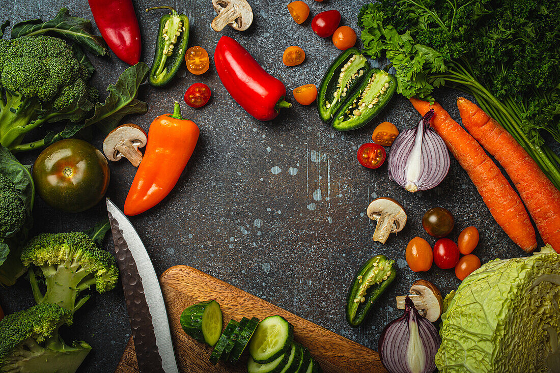 Assorted fresh vegetables on rustic concrete table