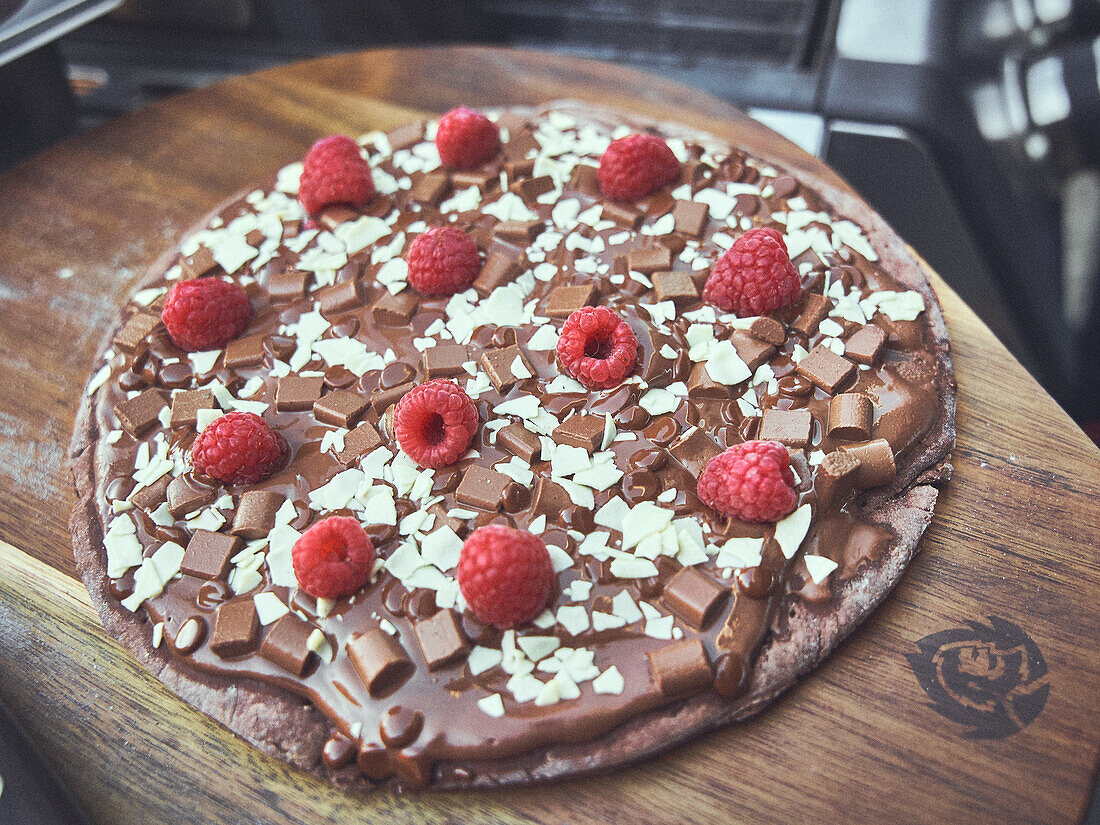 Dessert pizza with chocolate and raspberries