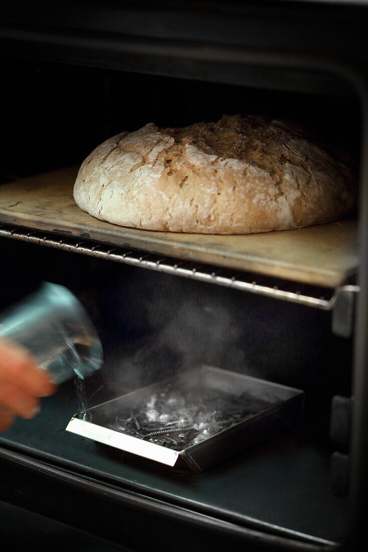 Steaming bread loaf in the oven