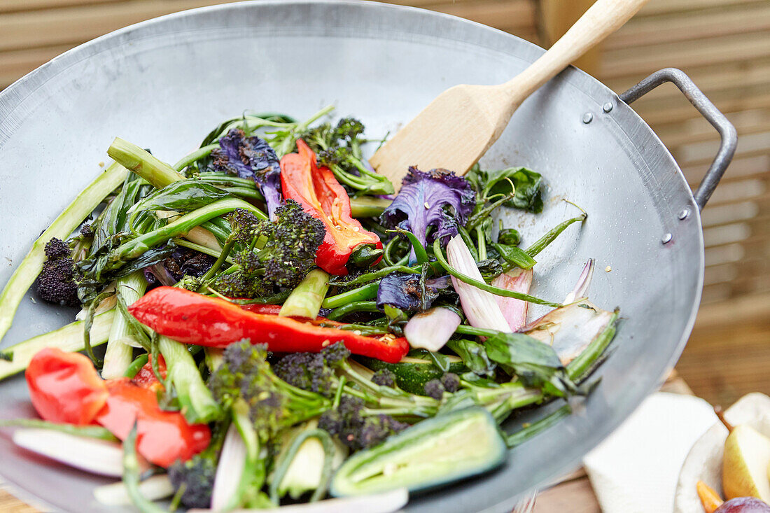 Mixed sauteed vegetables in a pan during outdoor cooking