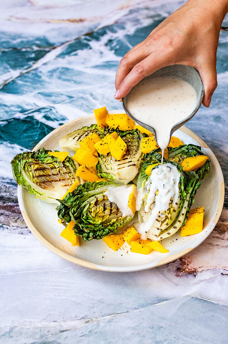 Mango and black pepper with charred lettuce and horseradish dressing