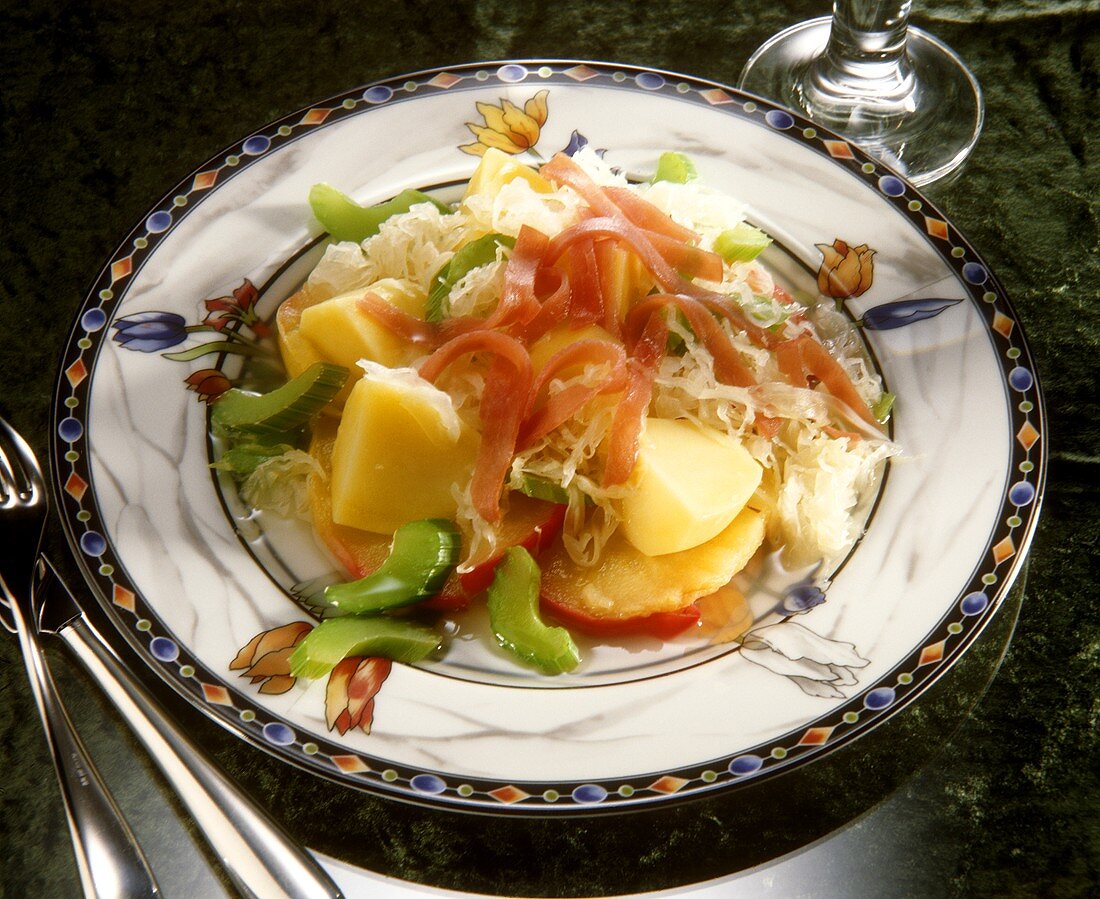 Sauerkraut salad with potatoes, apples, celery and ham