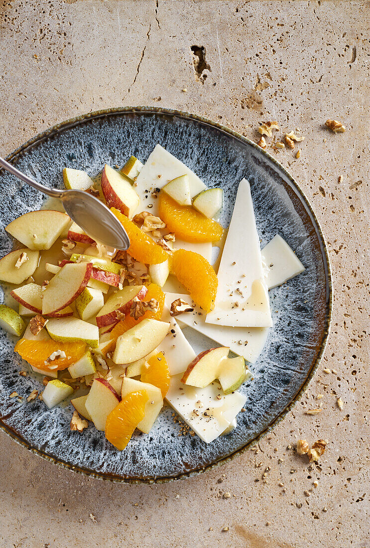 Fruit salad with goat's cheese, walnuts, and honey marinade