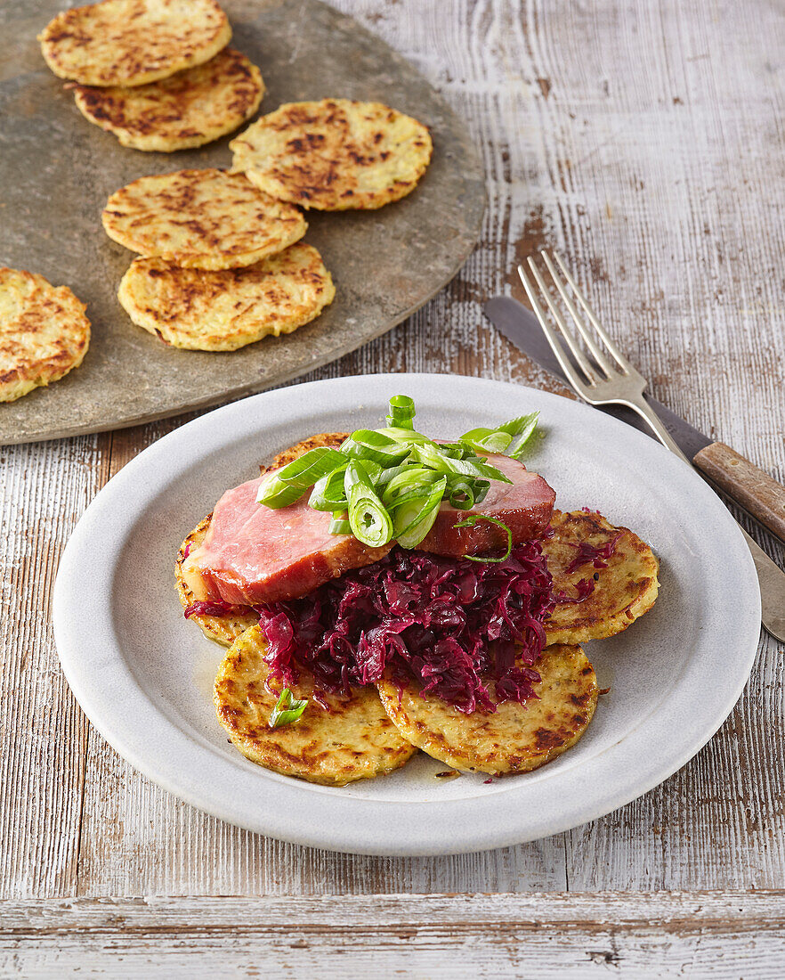 Small potato pancakes with braised red cabbage and smoked pork