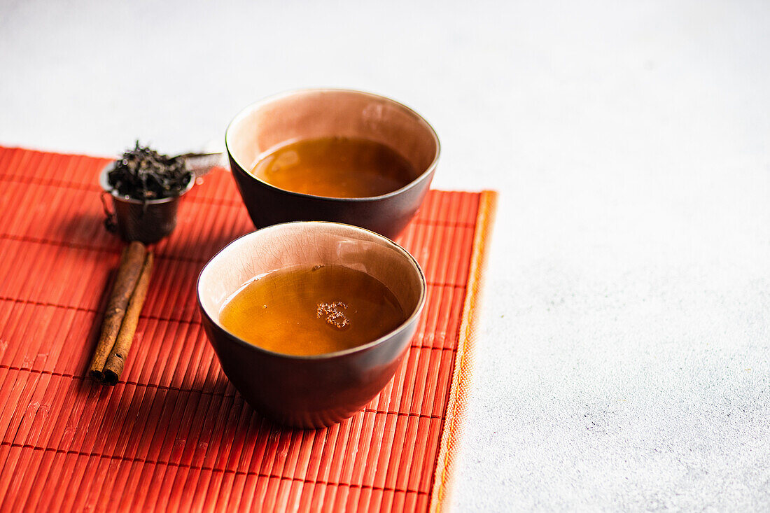 Tasty spring green tea in cups on stone table