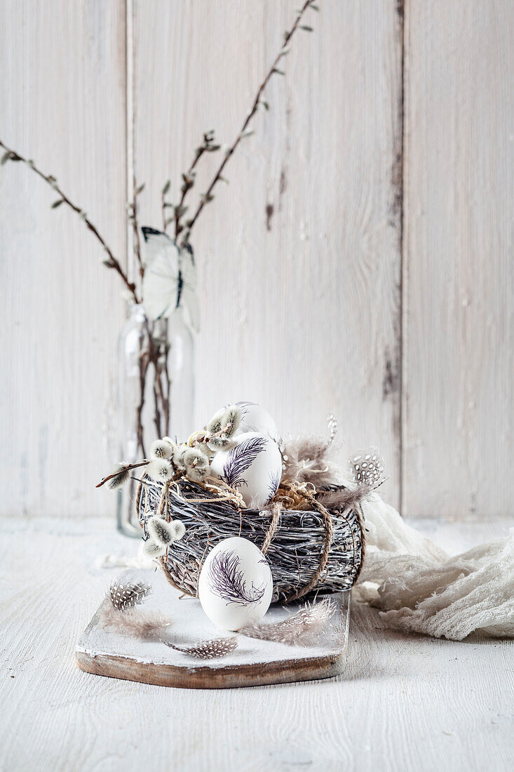 Painted Easter eggs, nest, feathers and willow catkins