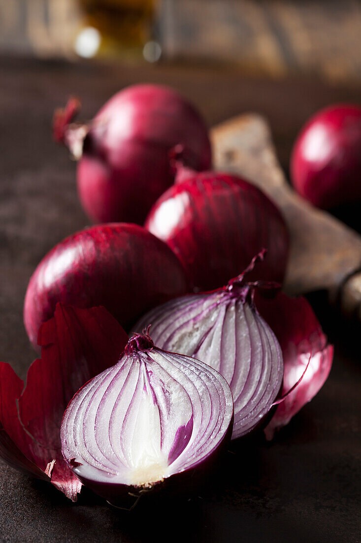 Whole and sliced red onions, close-up