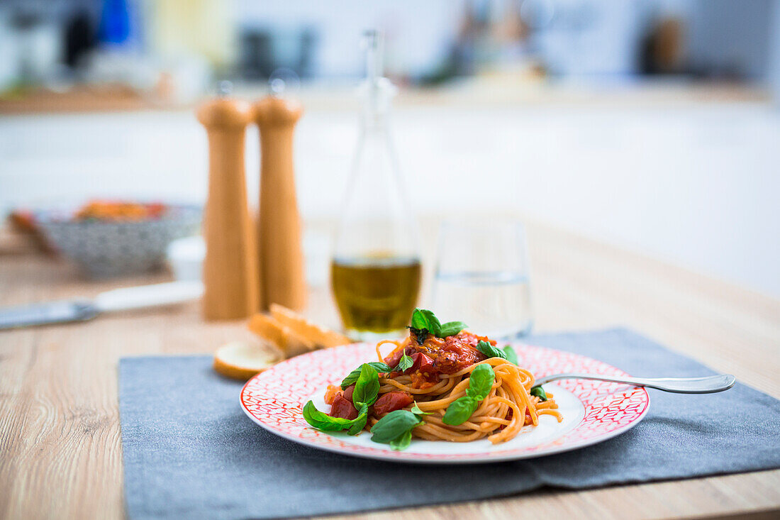 Spaghetti with cherry tomatoes and basil on a plate