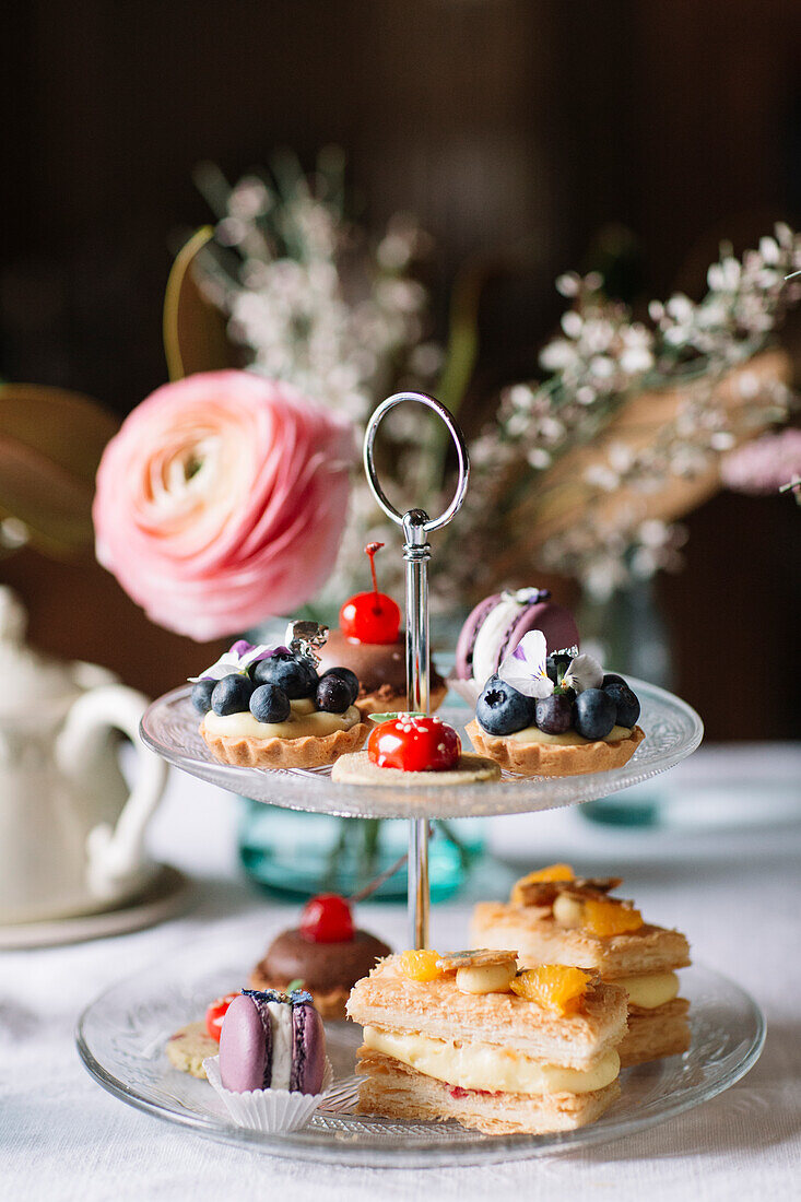 Various pastries on glass cake stand