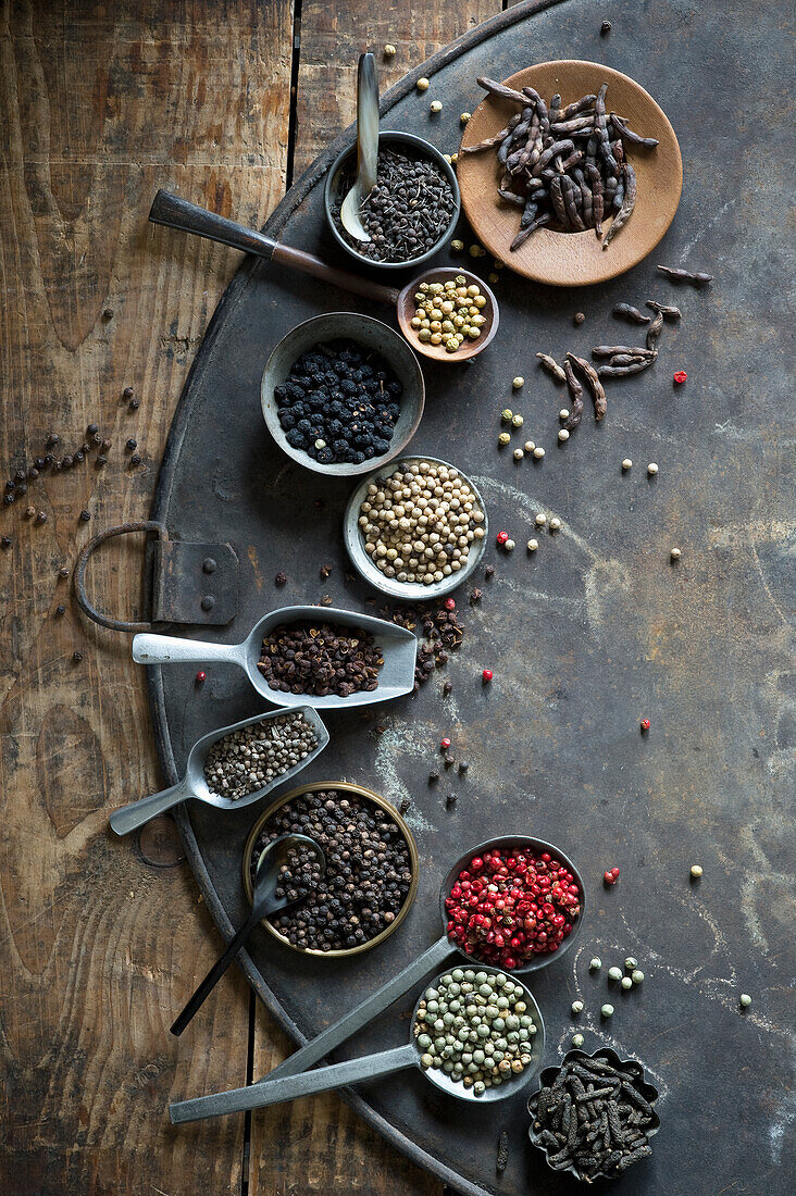 Bowls, ladles, and scoops of various peppercorns