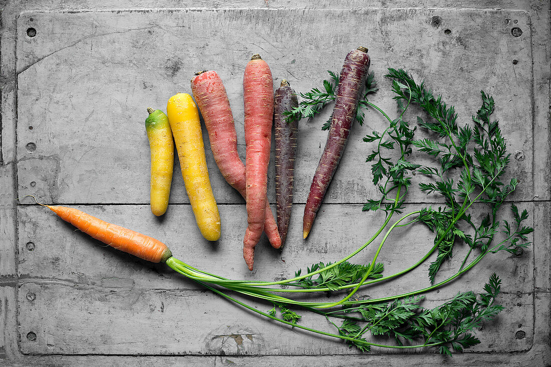 Carrots lying on gray wooden surface