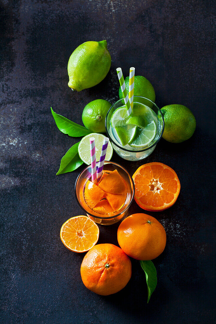 Limes and tangerines on dark background