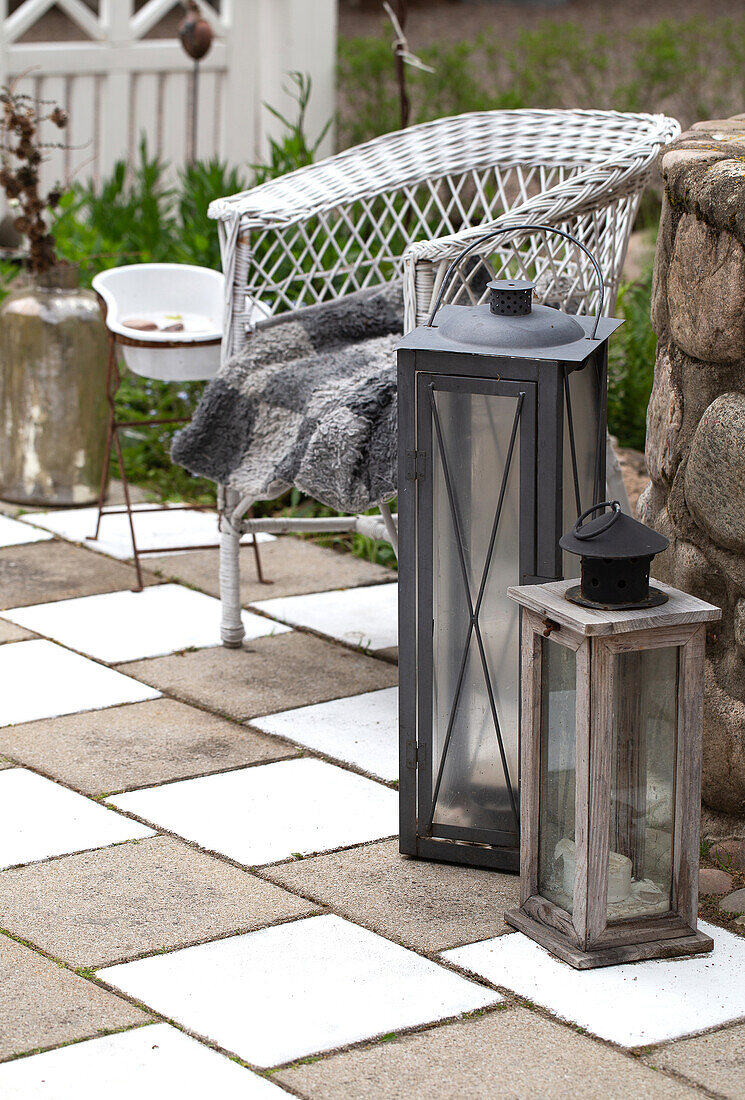 Lanterns and rattan chairs on painted concrete slab patio