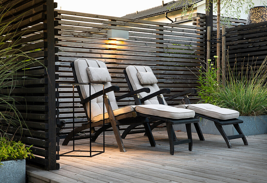 Three loungers on a wooden terrace