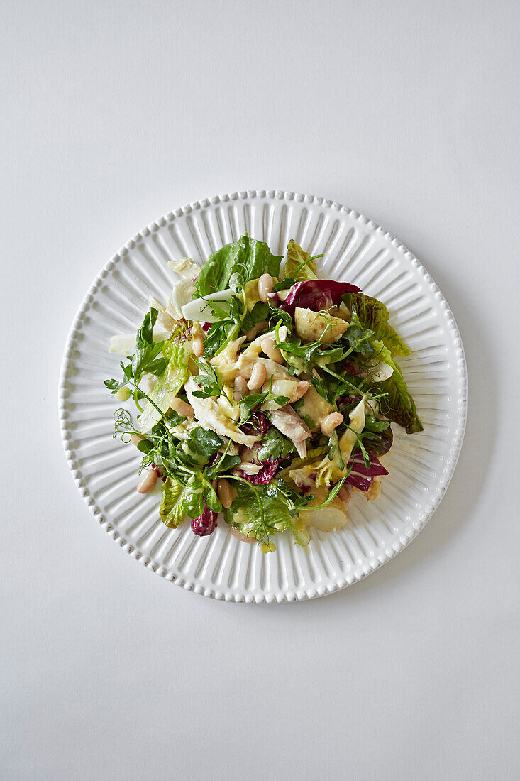 Chicken, potato, cannellini bean and leaf salad with dressing