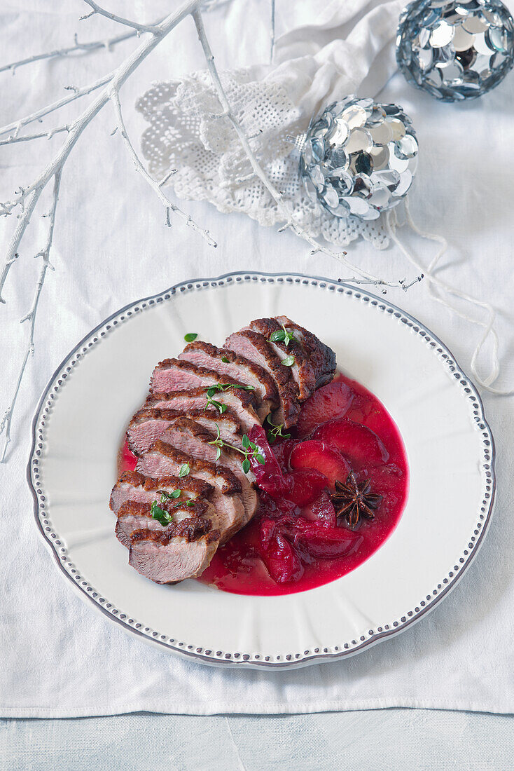 Sliced duck breast with plum sauce for Christmas
