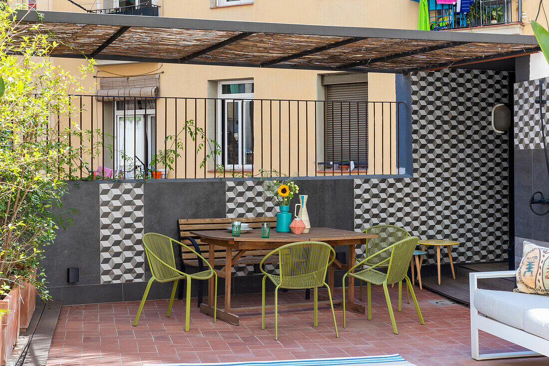 Classic chairs around dining table on the terrace with wooden floor and tiled walls in a 3D look