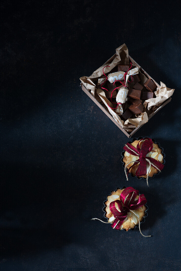 Small rum cakes with almonds and homemade marzipan confectionery for gifting