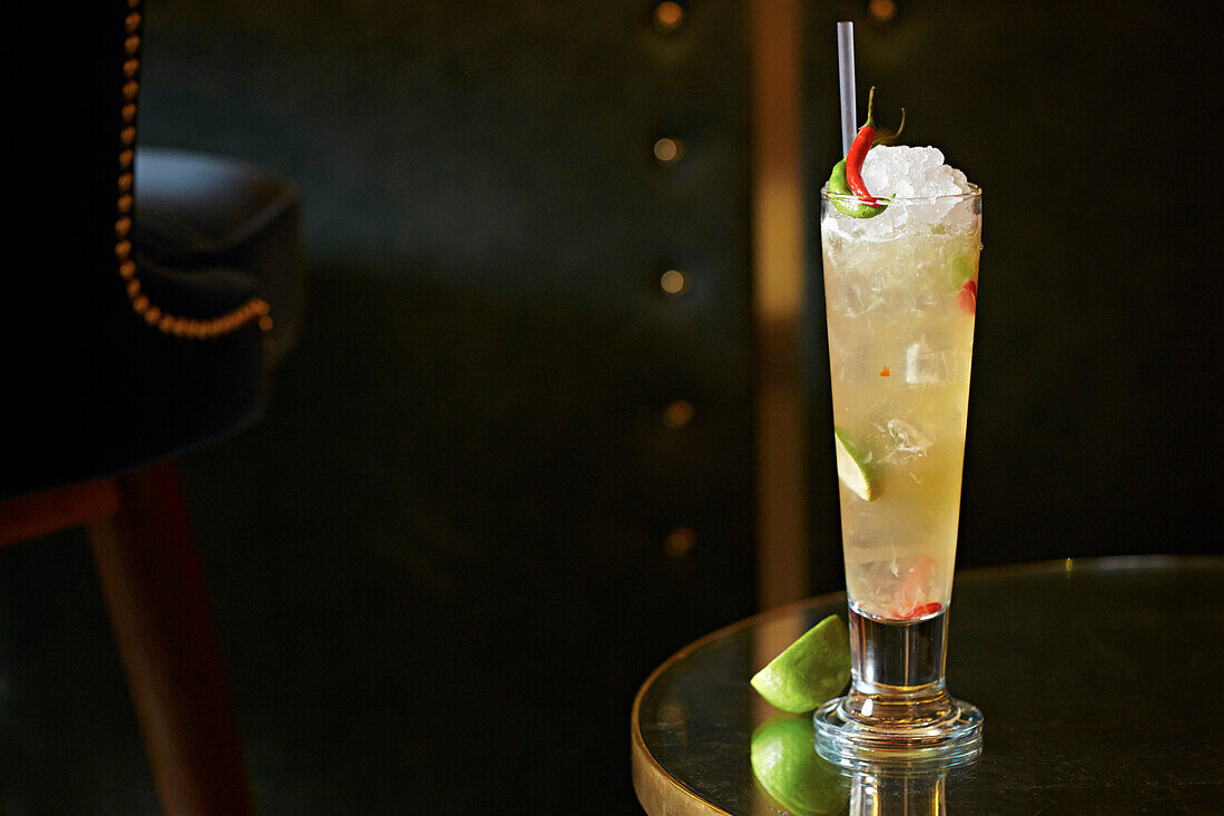 A lime and chilli cocktail in a highball glass