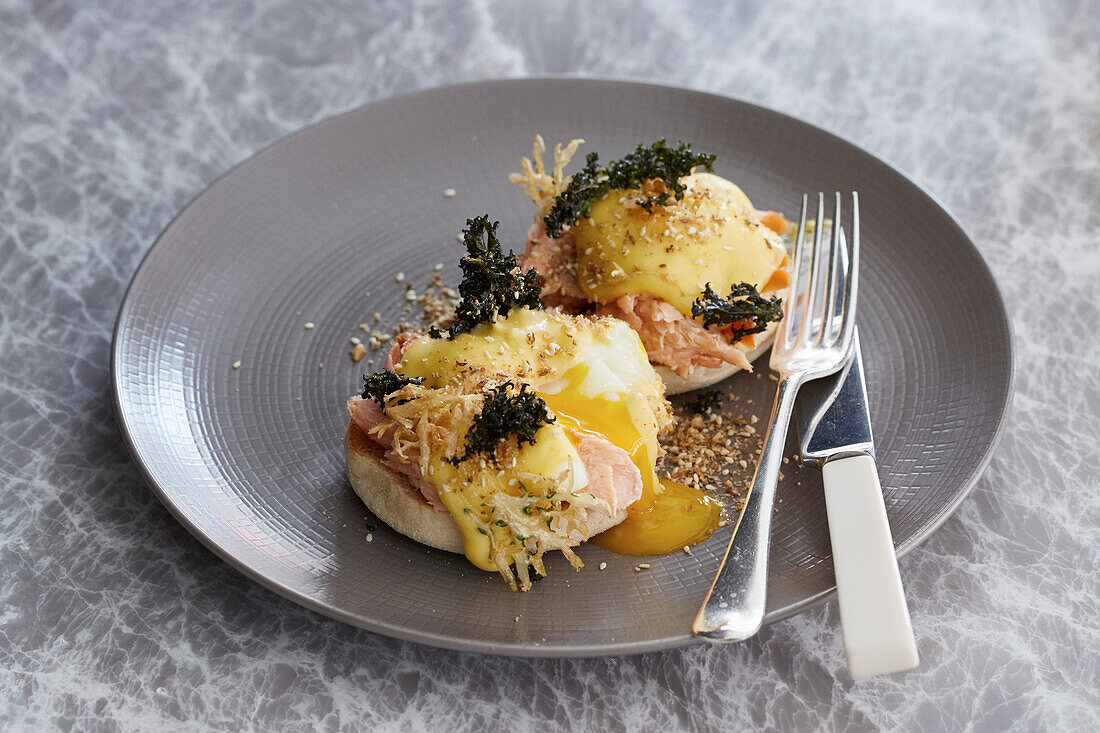 An English muffin with poached eggs and smoked salmon