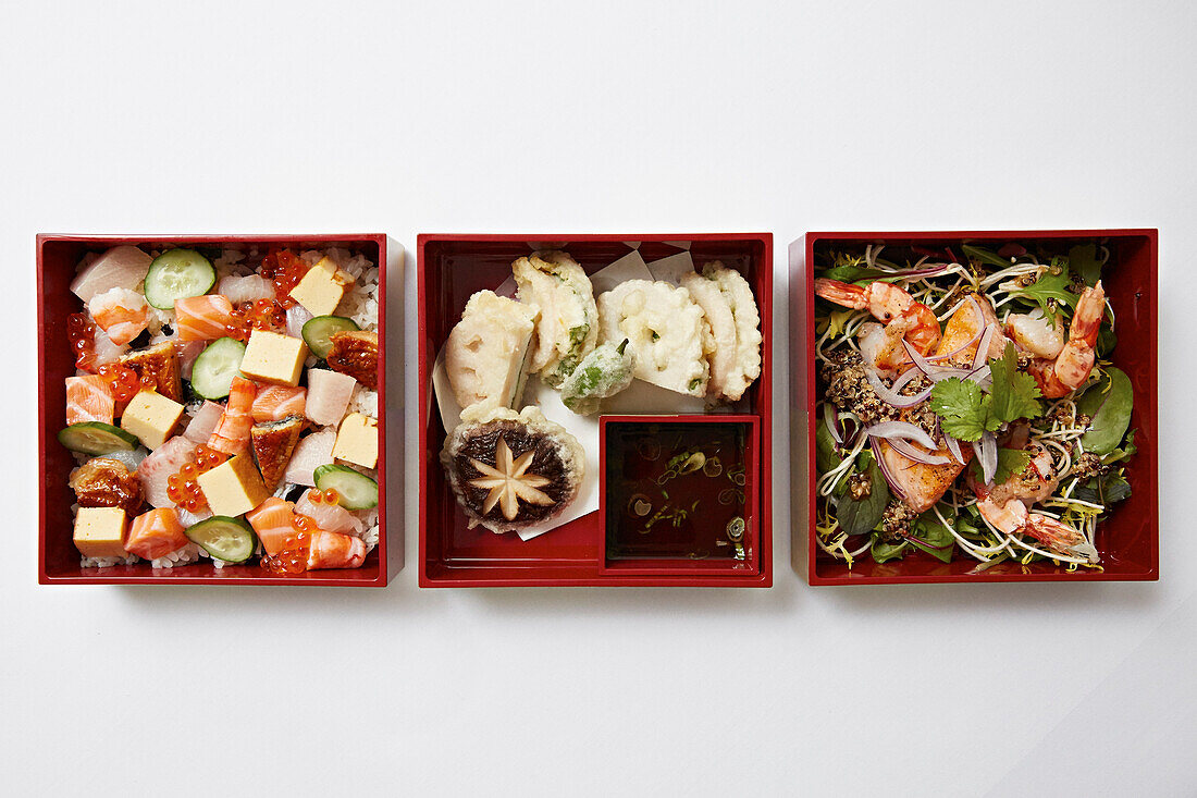 Bento boxes with sushi, tempura dn prawns
