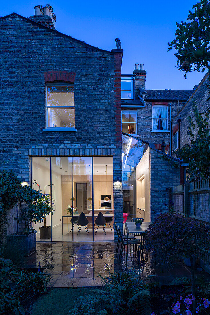 View from twilit garden into illuminated interior