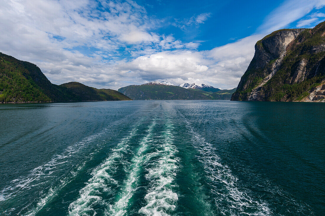Boat's wake streaks through Geirangerfjord, Norway