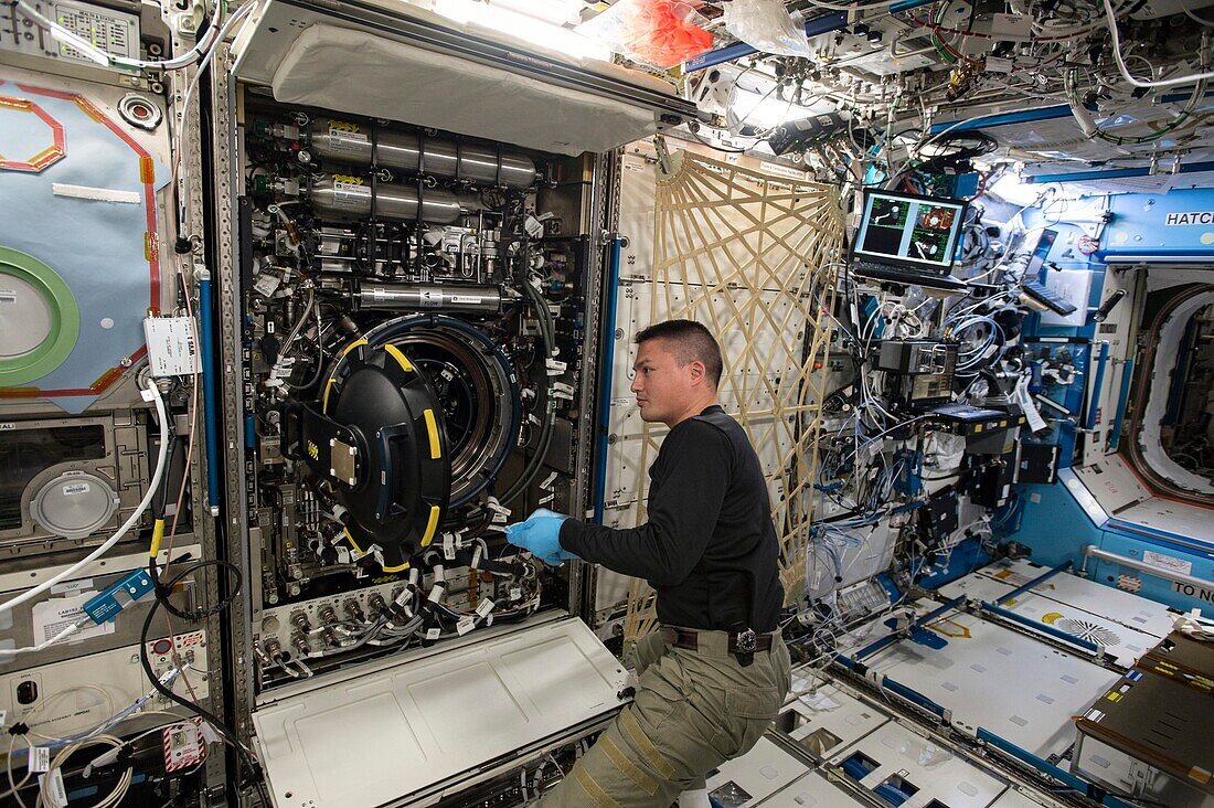 Astronaut replacing items on the ISS