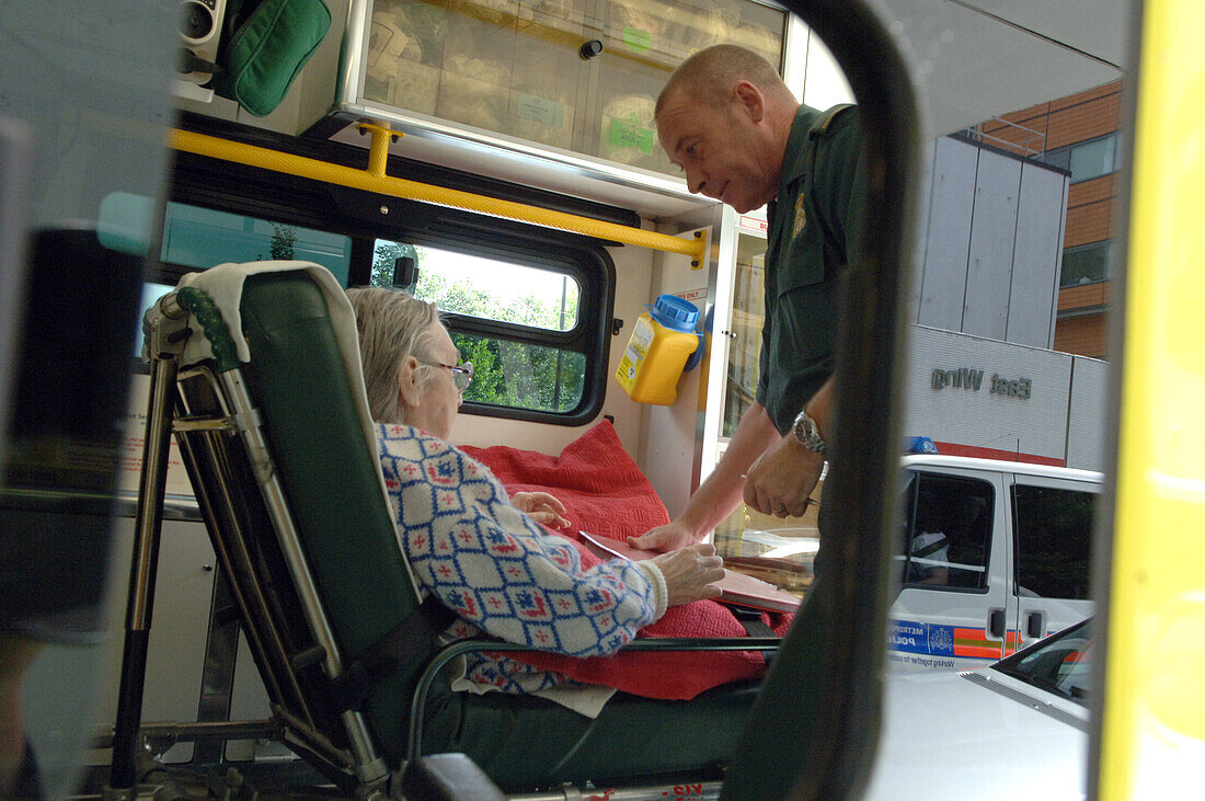 Paramedic providing care to elderly female patient