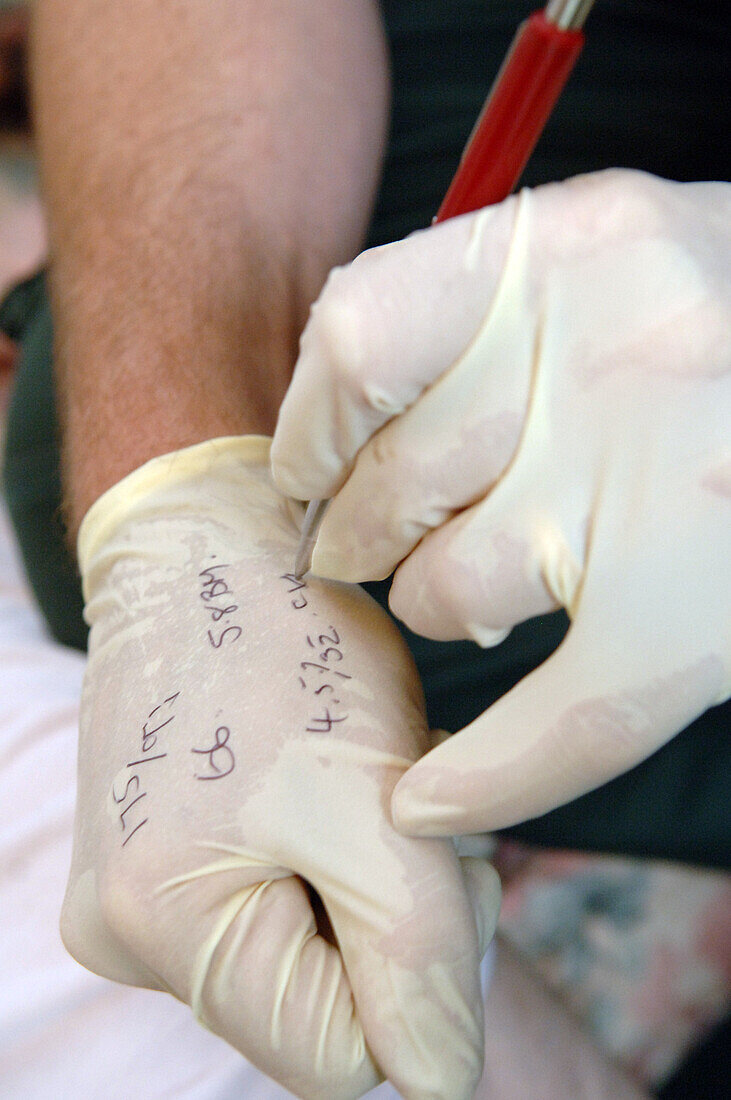 Patient information on paramedic's gloves