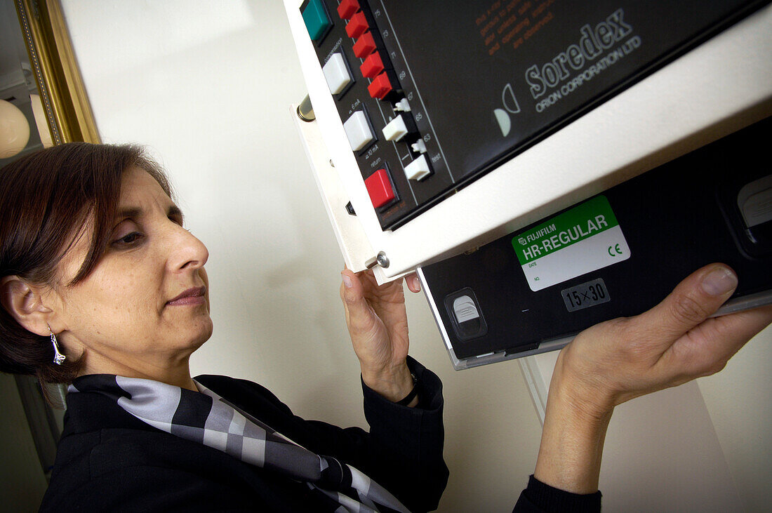 Radiographer setting up X-ray machine