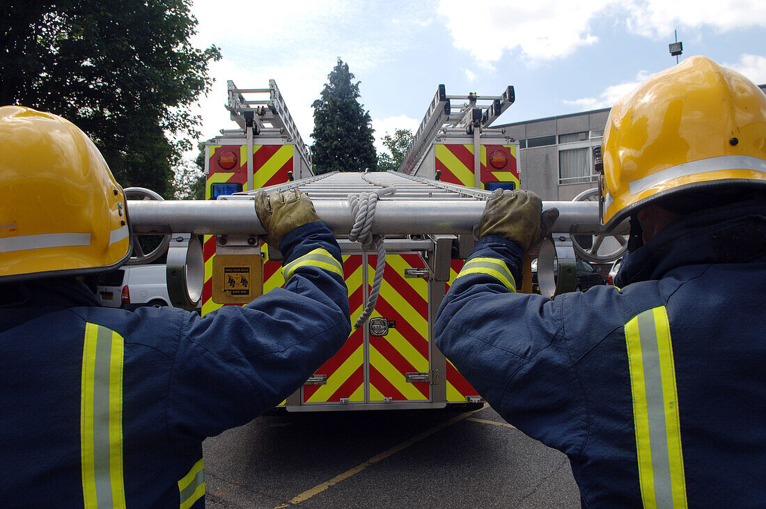 Firefighters extending ladder