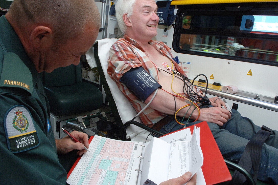 Paramedic filling out a form on behalf of his patient