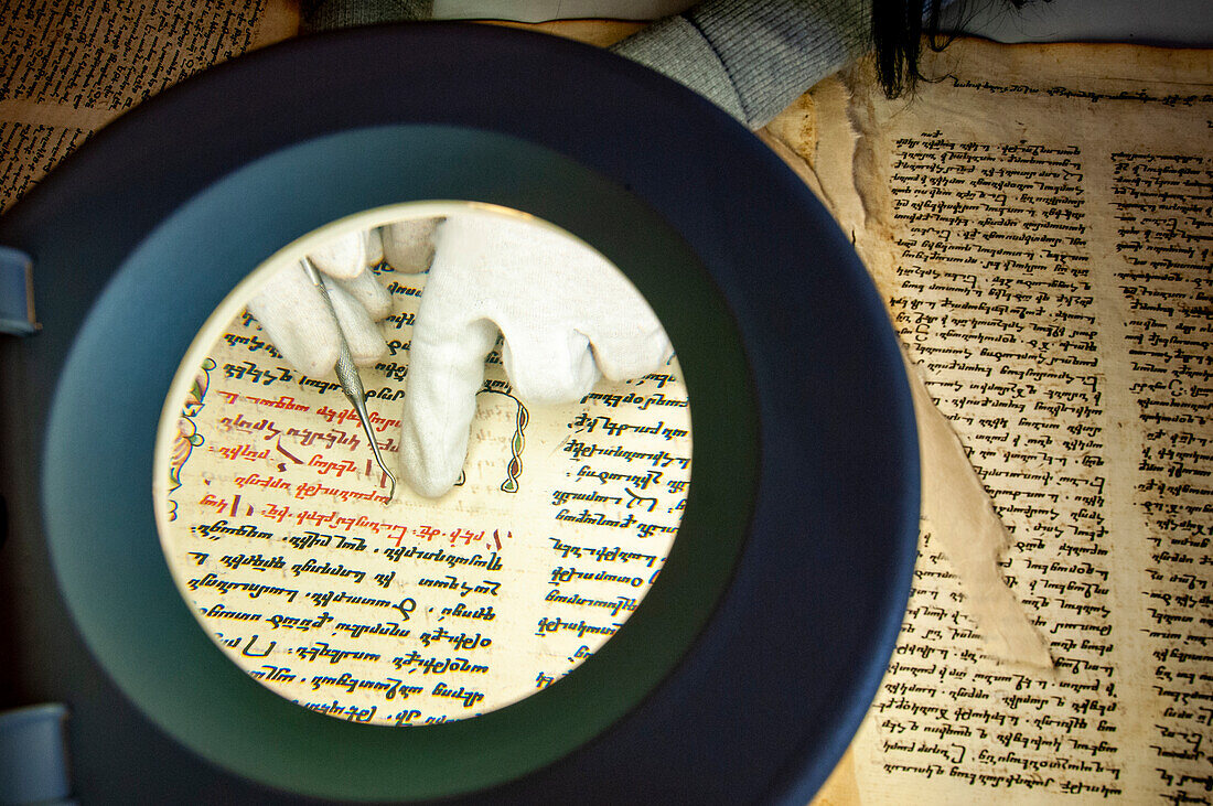 Restorer restoring an old manuscript