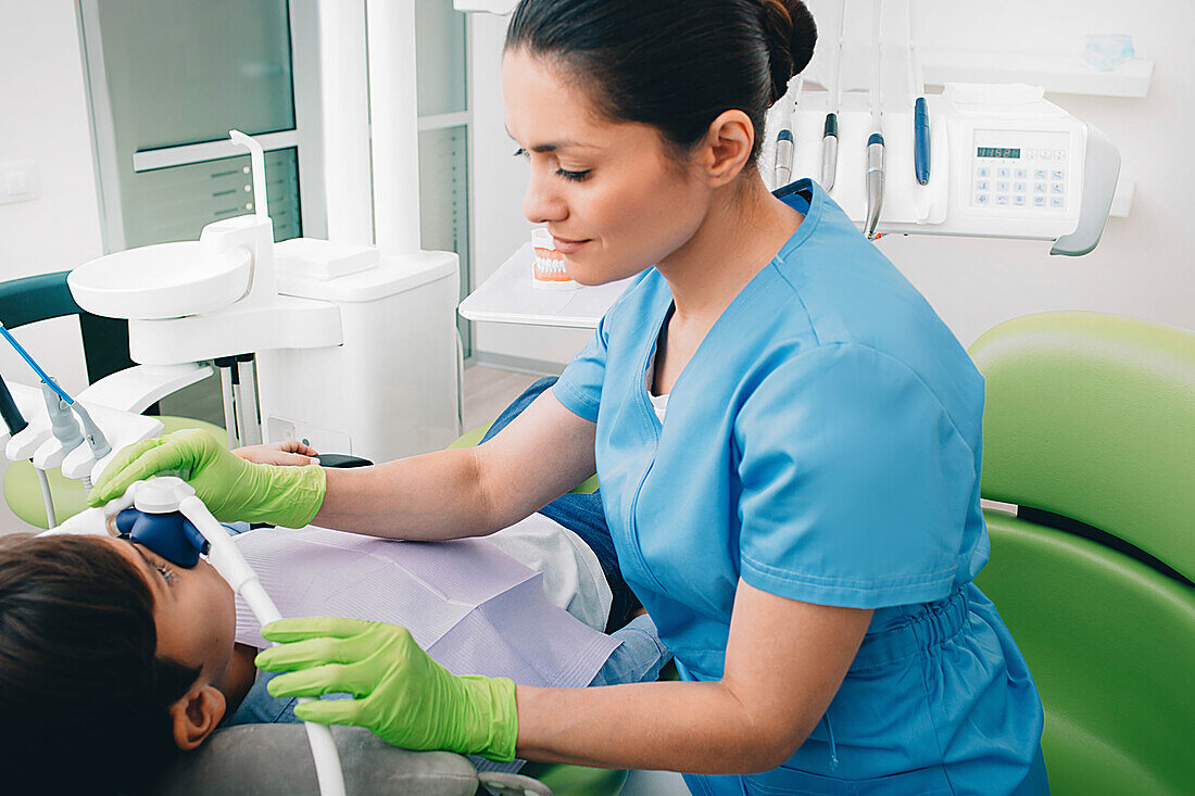 Dentist administering nitrous oxide