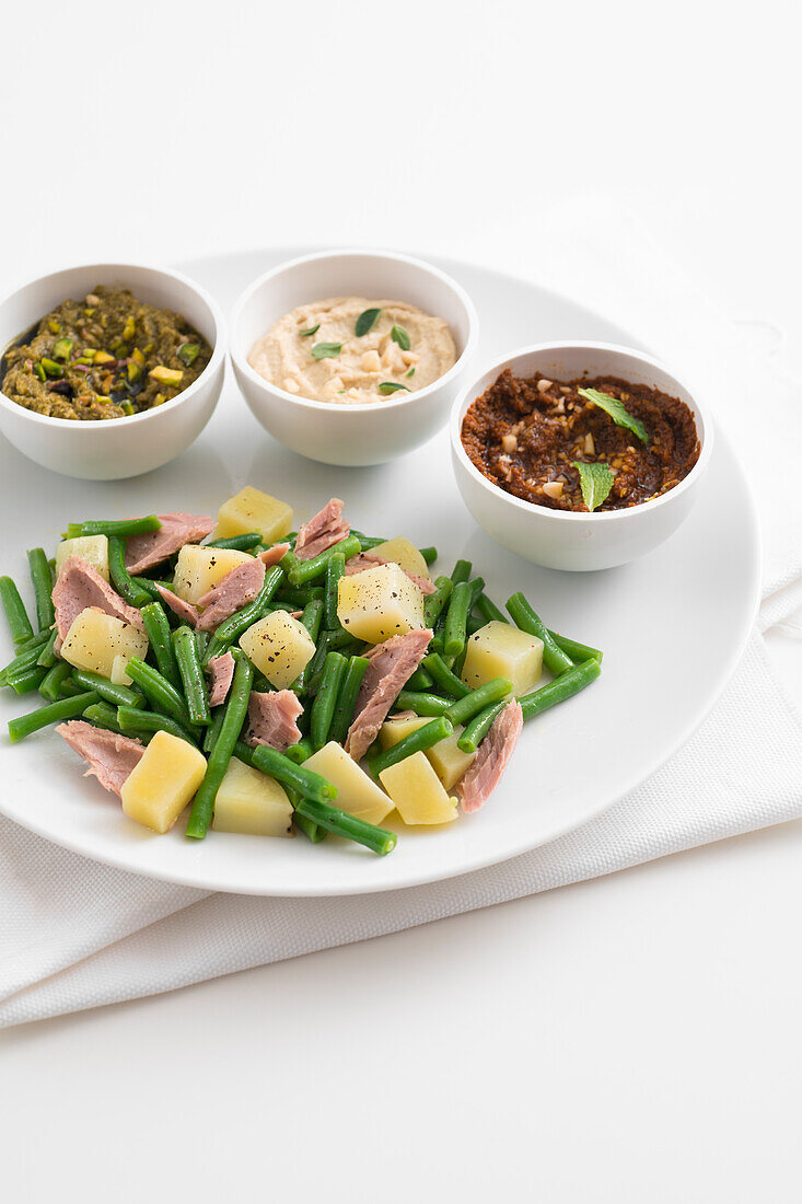 Salad with tuna, potatoes and green beans served with three kinds of pesto