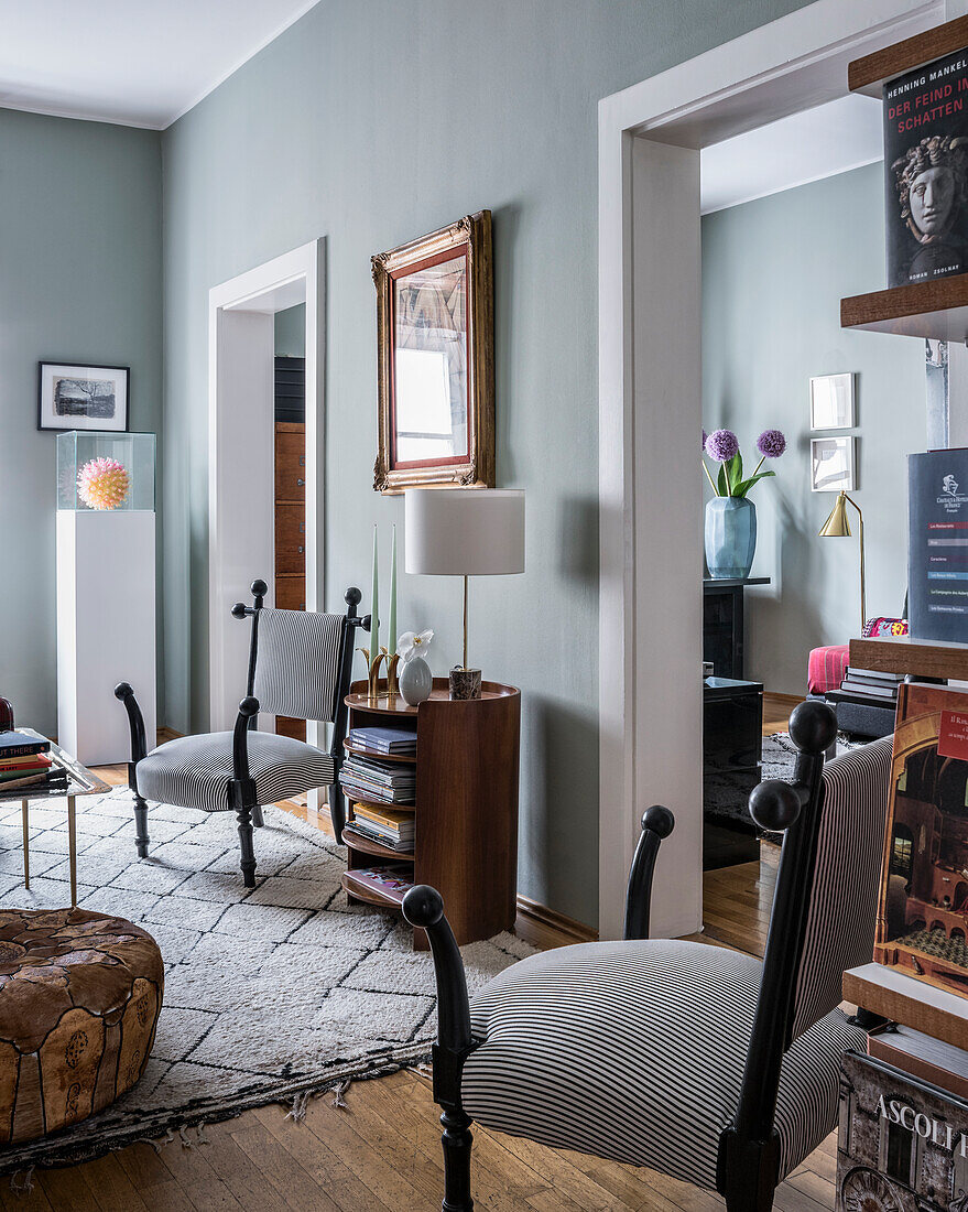 Pair of striped officer's armchairs in eclectically furnished sitting room